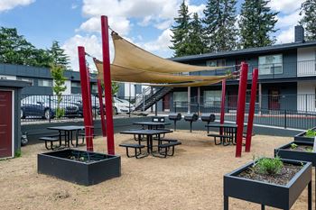 Community area with bbqs, picnic area, garden beds, bean bag toss, and boccie ball